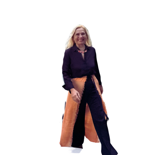 Woman wearing a black shirt and orange skirt on a white background